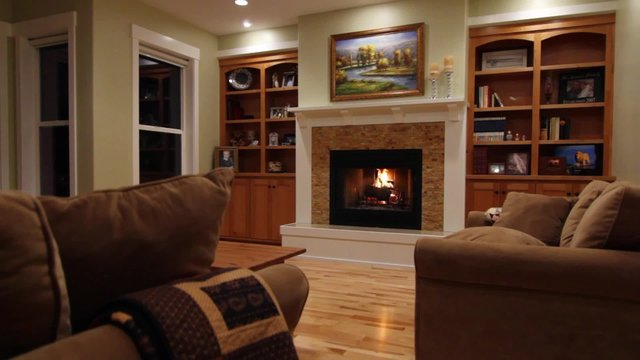 a jib shot of a roaring fireplace in the living room