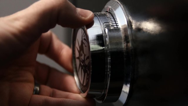 A man opening a safe