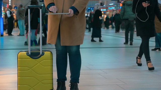 Woman traveler using pad at the airport