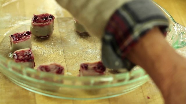 a woman making tasty berry pie pastries