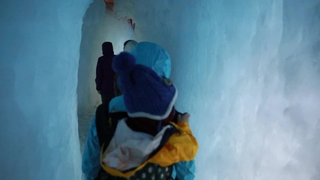 families walking in a ice cave