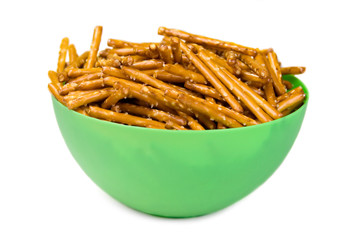 Pretzel Bowl – A green bowl of stick pretzels. Isolated on a white background.