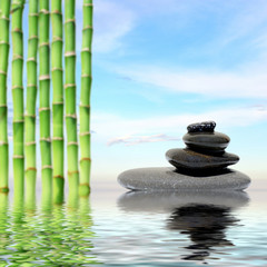 Zen spa concept background-Zen massage stones and bamboo reflected in water