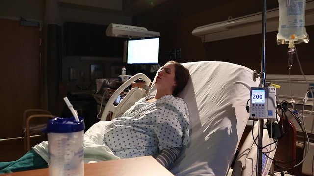a woman in labor with an iv in her arm for antibiotics at hospital