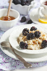 Homemade Oatmeal with Blackberries, granola and honey for Breakf