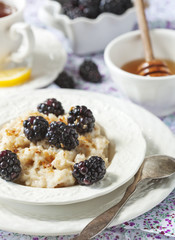 Homemade Oatmeal with Blackberries, granola and honey for Breakf