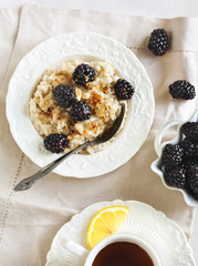 Homemade Oatmeal with Blackberries, granola and honey for Breakf