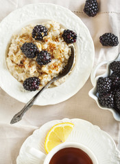 Homemade Oatmeal with Blackberries, granola and honey for Breakf