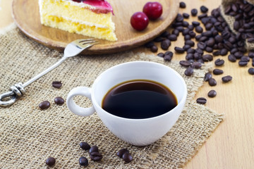 Coffee and cherry cheesecake with beans, delicious dessert on sack