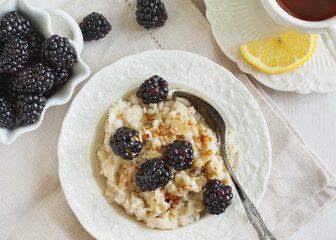Homemade Oatmeal with Blackberries, granola and honey for Breakf