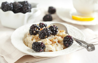 Homemade Oatmeal with Blackberries, granola and honey for Breakf