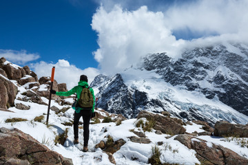 Woman Traveler with Backpack hiking in Mountains