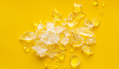 crushed ice on vibrant yellow background