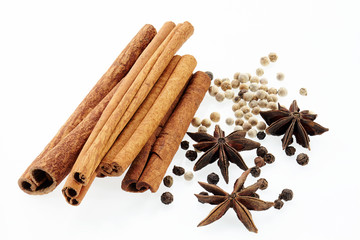 Cinnamon, poikak, black and white peppercorn. Isolated on white background.