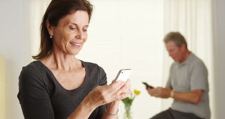 Happy senior woman using smartphone