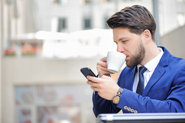 Pleasant young man sitting in cafe