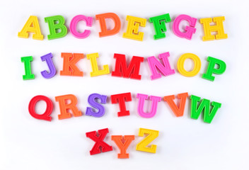 Colorful plastic alphabet letters on a white