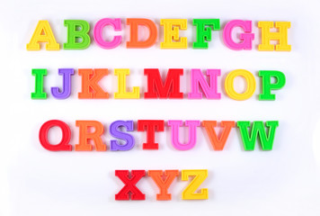 Colorful plastic alphabet letters on a white
