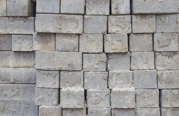 Grey square bricks stacked in rows in the center of city