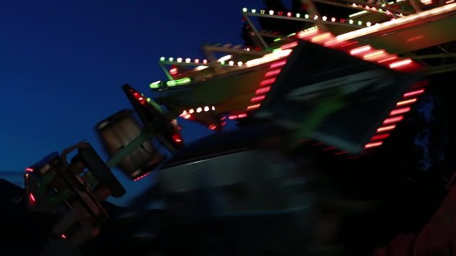 a carnival ride at night with the flashing lights