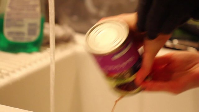 draining a can of black beans