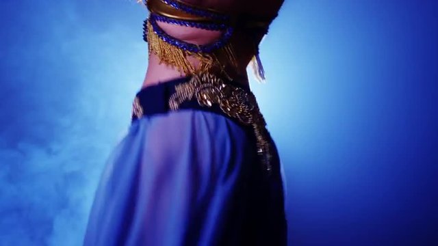 Rear view of Argentinian woman belly dancer shaking hips