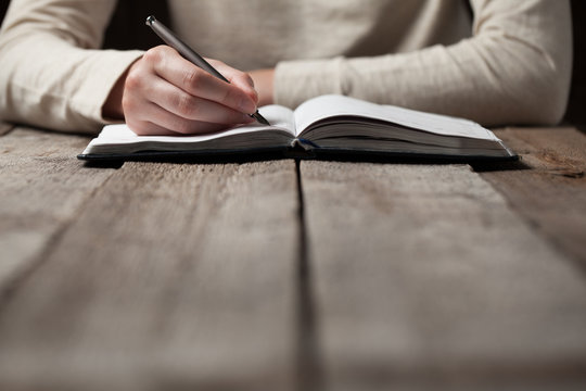 woman writing in a notebook