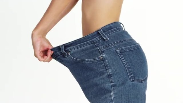 Skinny woman wearing big jeans