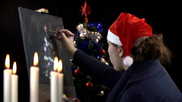 Young art creator painting Christmas tree