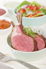 Lamb Cutlets - Spicy roasted lamb cutlets in a bowl served with salad and dips
.
