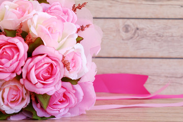 Pink roses against a wood wall