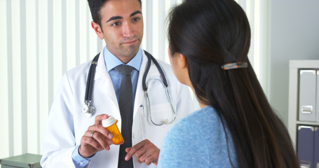 Hispanic doctor explaining new prescription to patient