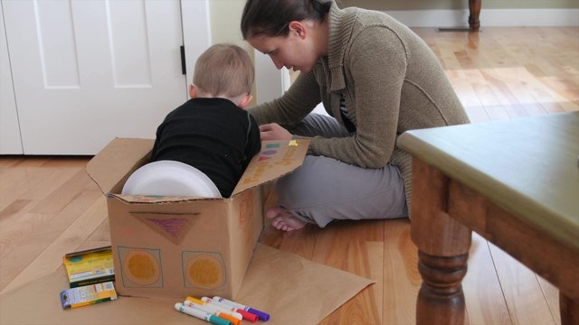 A mom making a spaceship with her toddler