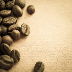 Fototapeta na wymiar coffee beans on vintage color paper background 