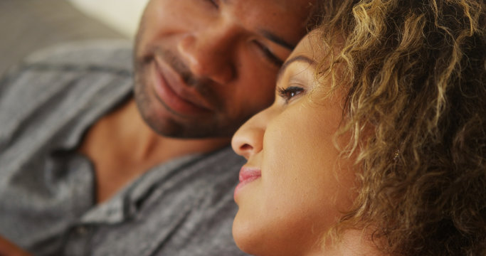 Black couple resting their heads together