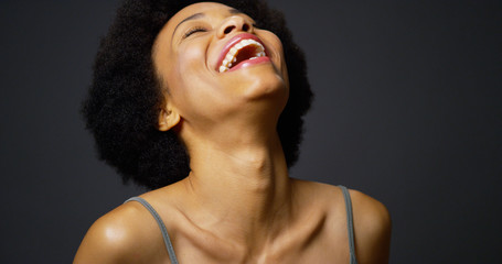 Slow pan up casual black woman laughing and smiling - obrazy, fototapety, plakaty