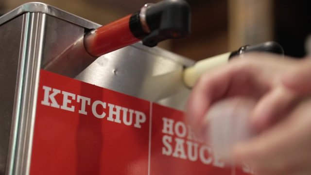 woman getting ketchup fast food