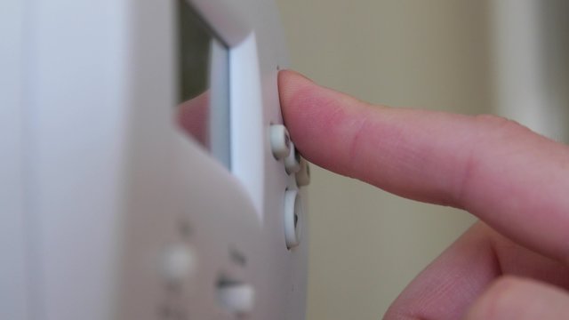 Changing the temperature on a wall thermostat
