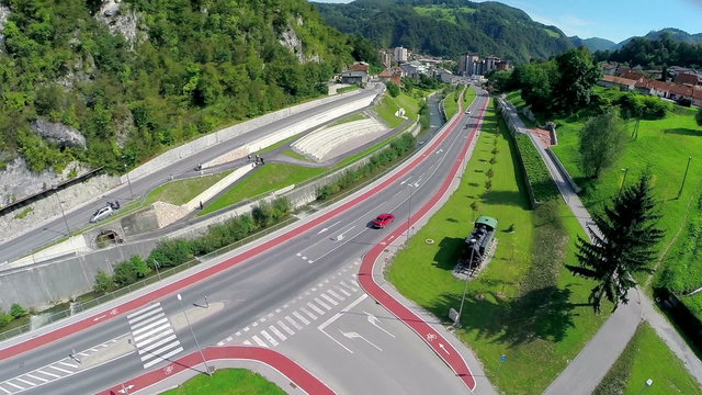 Flying over new street with park and locomotive statue in Zagorje