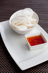 crisp rice, dish of crisp cracker with sauce