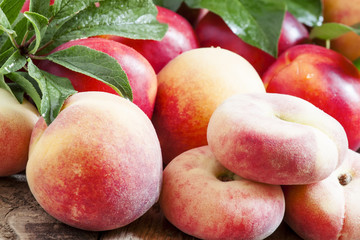 Assortment of peaches: big peaches, nectarines, flat peaches wit