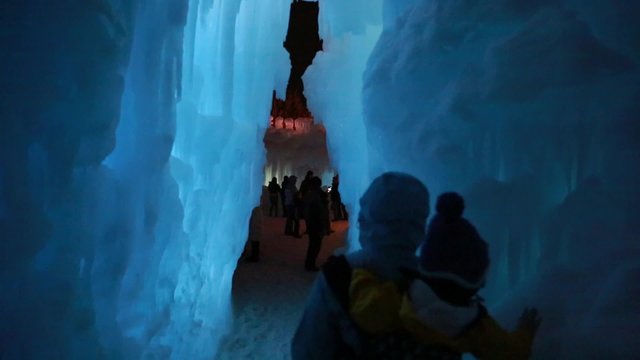 people walking in a ice cave