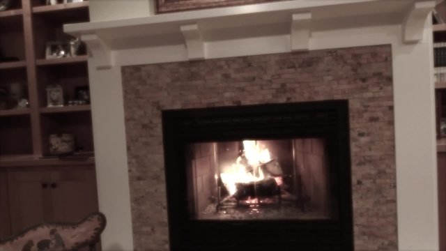 rocking chair by a cozy fireplace jib shot