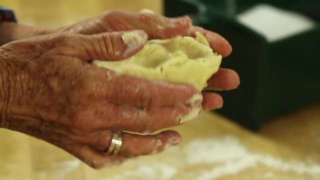 woman forming pie crust dough