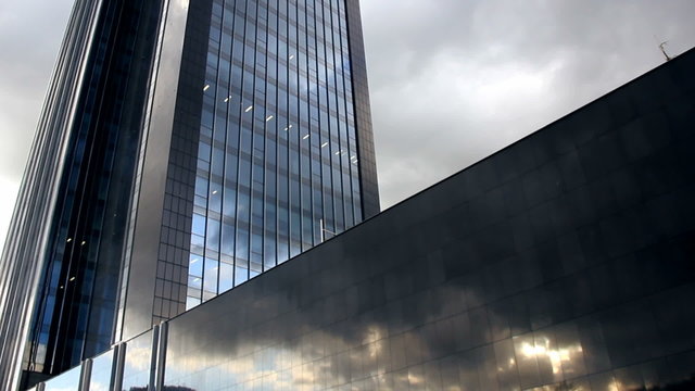 Skyscraper with reflections of cloudy weather in glass timelapse