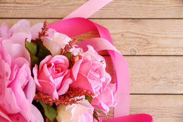 Pink roses against a wood wall