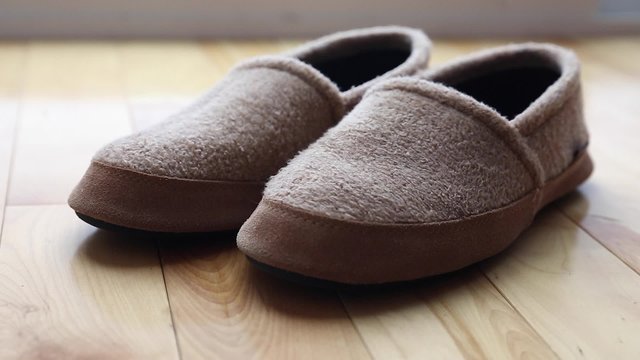 man wears a pair of slippers dolly shot