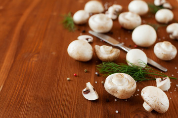 Fototapeta na wymiar Cultured mushrooms champignons on wooden rustic background