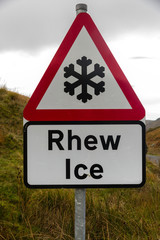 Snowflake ice triangular warning sign, bilingual Rhew, Wales, Un