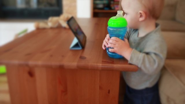 little cute boy watching a movie on a tablet